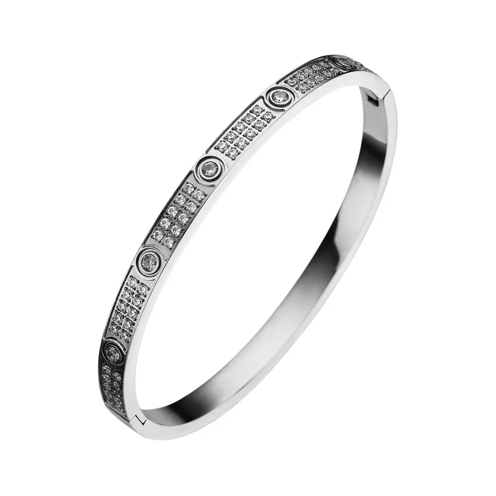 Pulsera y brazalete contemporáneo de cruz con clavo tipo tuerca en zirconia dorada 2023 para mujer en acero inoxidable.